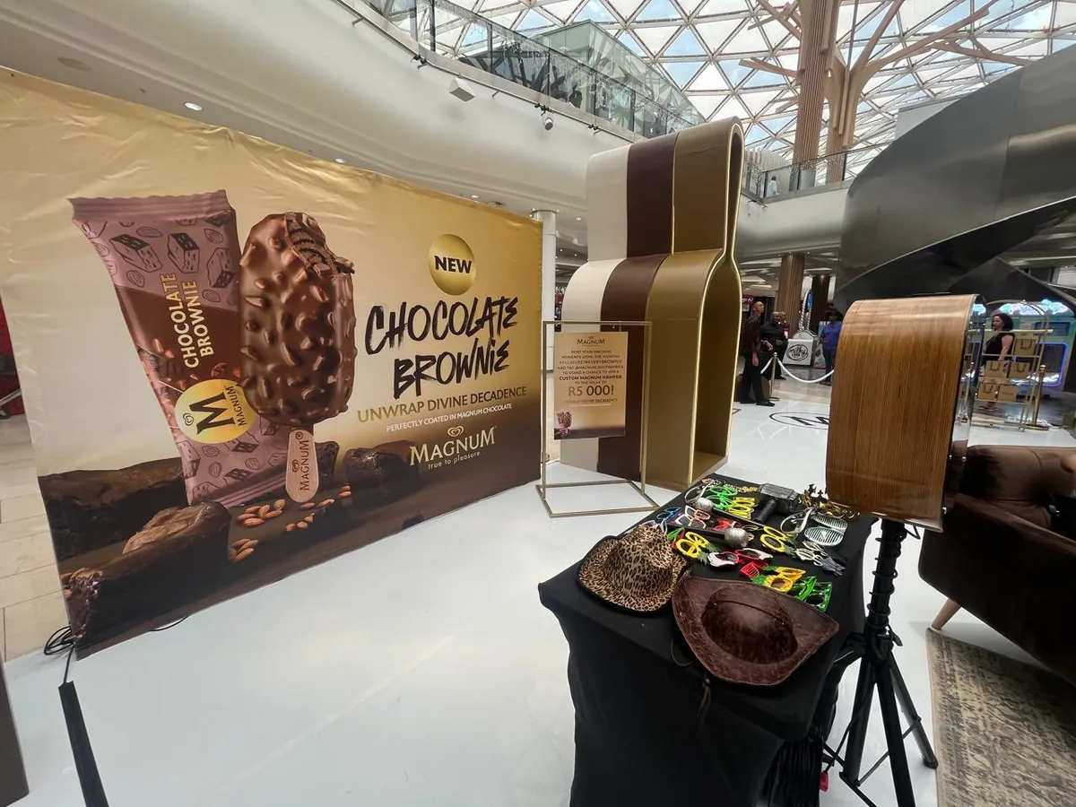 Solo Selfie Cube with beauty-dish lighting and props at a branded activation