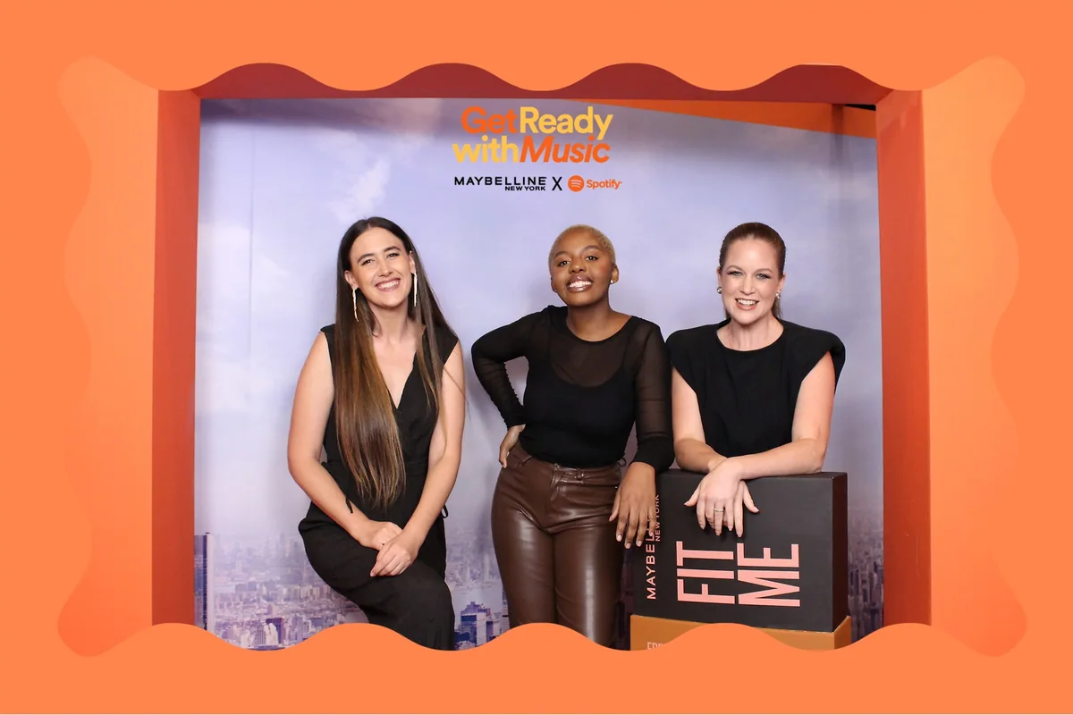 Orange Maybelline and Spotify postcard print with three guests